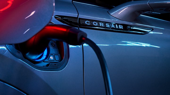 A charger plugged into the charging port of a 2024 Lincoln Corsair® Plug-in Hybrid model. | Pines Lincoln in Pembroke Pines FL